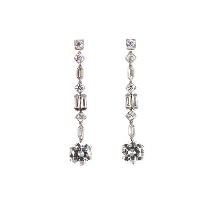 Pair of diamond pendant earrings of geometric design, each hung with a principal round brilliant cut diamond | MasterArt